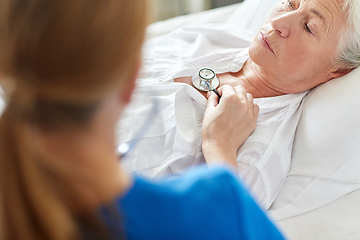 Image showing doctor with stethoscope and old woman at hospital