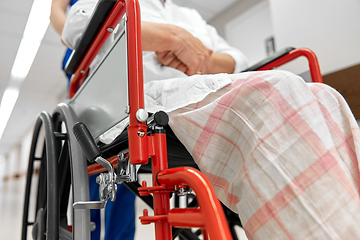 Image showing nurse with senior patient in wheelchair at clinic