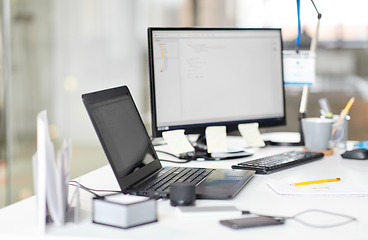 Image showing laptop computer and gadgets on table at office