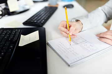 Image showing businesswoman with notebook and laptop at office