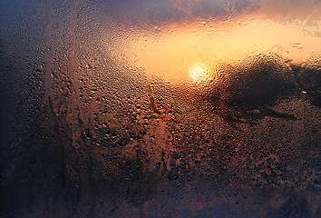 Image showing Melting ice, water drops and sunlight in a winter morning on gla