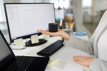 Image showing businesswoman using smart speaker at office