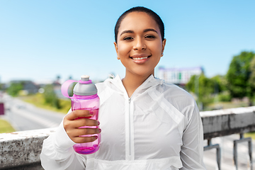 Image showing african american woman drinking water from bottle