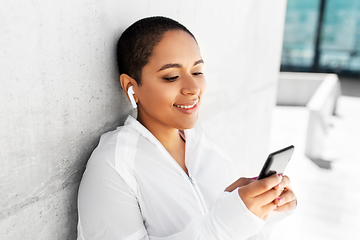 Image showing african american woman with earphones and phone