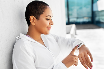 Image showing young woman with smart watch outdoors