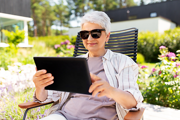 Image showing happy senior woman with tablet pc at summer garden