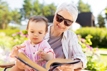 Image showing grandmother and baby granddaughter reading book