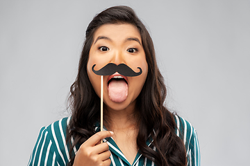 Image showing asian woman with vintage moustaches party prop