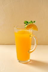 Image showing jug with orange juice and peppermint on table