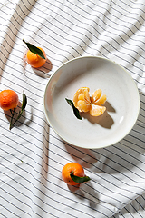 Image showing still life with mandarins on plate over drapery