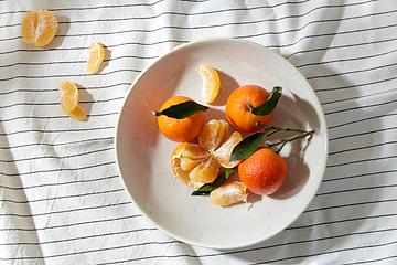 Image showing still life with mandarins on plate over drapery