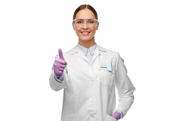 Image showing female scientist in goggles showing thumbs up