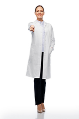 Image showing happy female doctor or scientist pointing to you