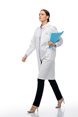 Image showing female doctor or scientist walking with folder