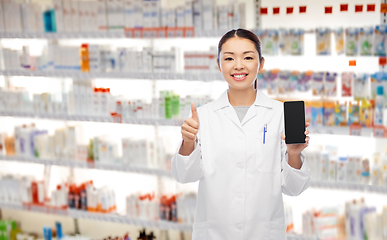 Image showing asian pharmacist with phone shows thumbs up