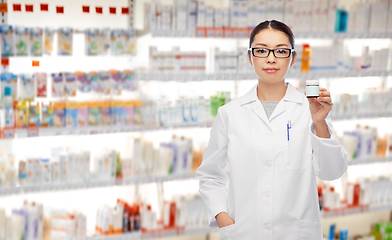 Image showing asian female pharmacist with medicine at pharmacy