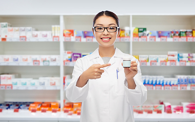 Image showing asian female pharmacist or doctor with medicine