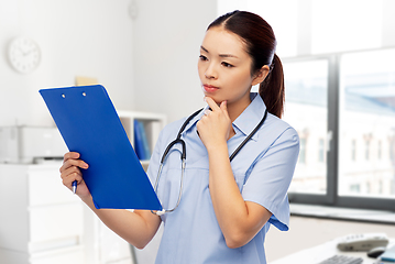 Image showing asian female doctor with clipboard at hospital