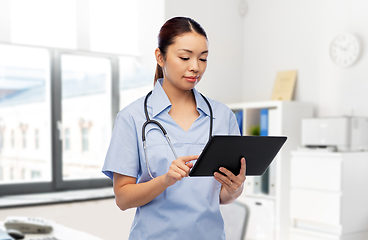 Image showing asian female nurse with tablet pc at hospital