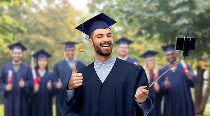 Image showing male graduate student with smartphone takes selfie