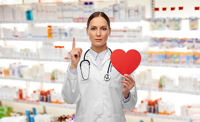 Image showing female doctor with heart pointing finger up