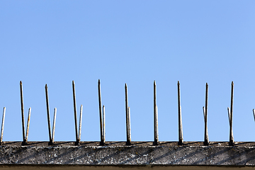 Image showing old fence spikes