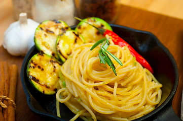 Image showing italian spaghetti pasta with zucchini sauce on iron skillet