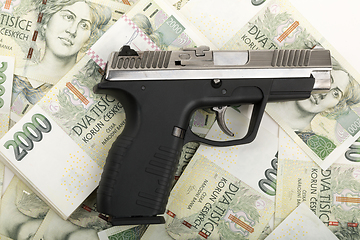 Image showing gun and czech banknotes, crime concept