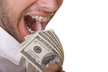 Image showing Eating money