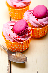 Image showing pink berry cream cupcake with macaroon on top