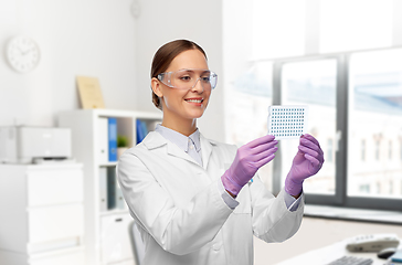 Image showing female scientist in goggles with chemical sample