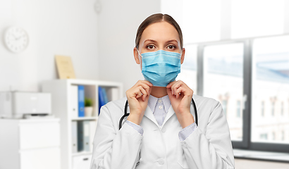 Image showing happy female doctor wearing medical mask