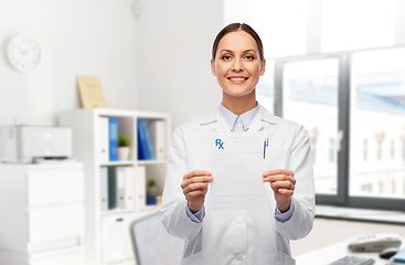 Image showing smiling female doctor with prescription blank
