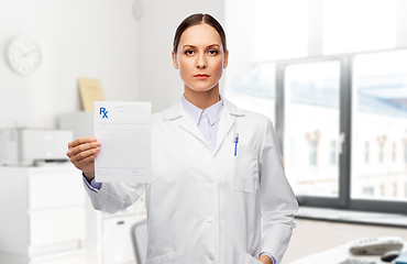 Image showing female doctor with prescription blank