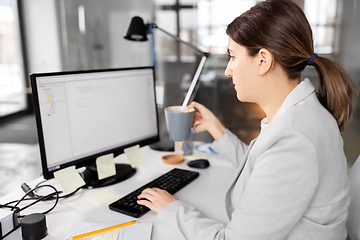 Image showing businesswoman with computer and coffee at office