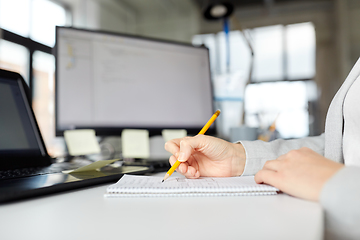 Image showing businesswoman with notebook and laptop at office