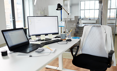 Image showing laptop computer and gadgets on table at office