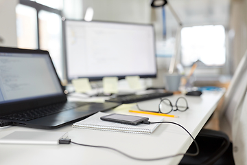 Image showing smartphone with powerbank on table at office