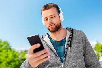 Image showing young man with headphones and smartphone