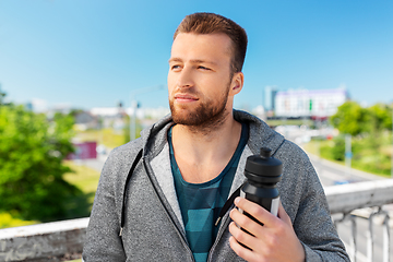 Image showing young man with sports bottle