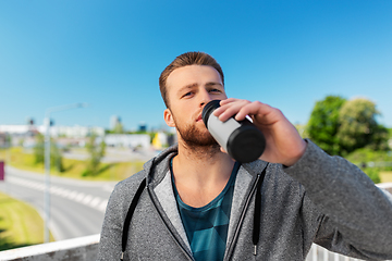 Image showing young man with sports bottle