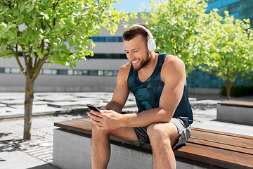 Image showing young athlete man with headphones and smartphone