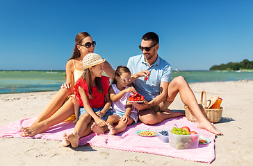 Image showing happy family having picnic on summer beach