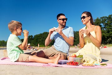 Image showing happy family having picnic on summer beach