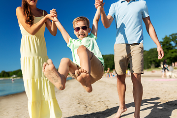 Image showing happy family walking along summer beach