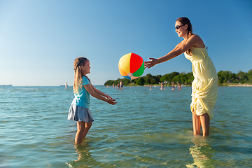 Image showing mother and daughter playing with ball on beach