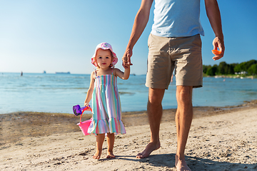 Image showing father walking with little daughter on beach