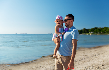 Image showing happy father with little daughter on beach