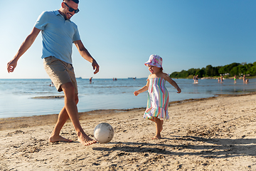 Image showing happy father and daughter playing ball on beach