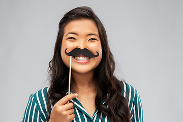 Image showing asian woman with vintage moustaches party prop